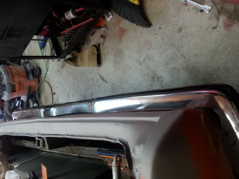 1973 Chevrolet Nova - Close-up view of a chrome bumper and fender, likely undergoing restoration or repair.