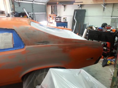 1973 Chevrolet Nova - The rear quarter panel of a car is shown undergoing bodywork in a garage setting.