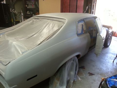 1973 Chevrolet Nova - This car is undergoing preparation for painting, with protective coverings on the windows and body panels.