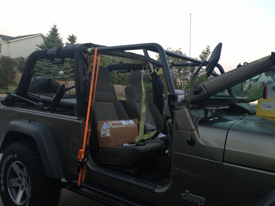Interior of a 2005 Jeep Wrangler with OR-Fab cage and cargo box on passenger seat
