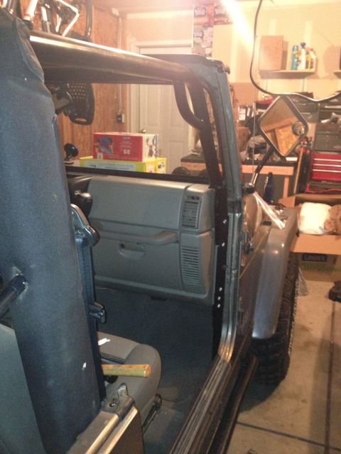 2005 Jeep Wrangler - Interior view of a Jeep Wrangler, showing the roll cage and dashboard area with stacked boxes.