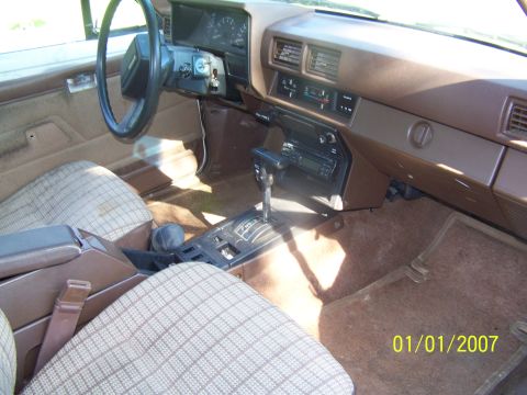 1988 Suzuki Samurai - Interior of a 1988 Suzuki Samurai, the dashboard, shifter, and seats.