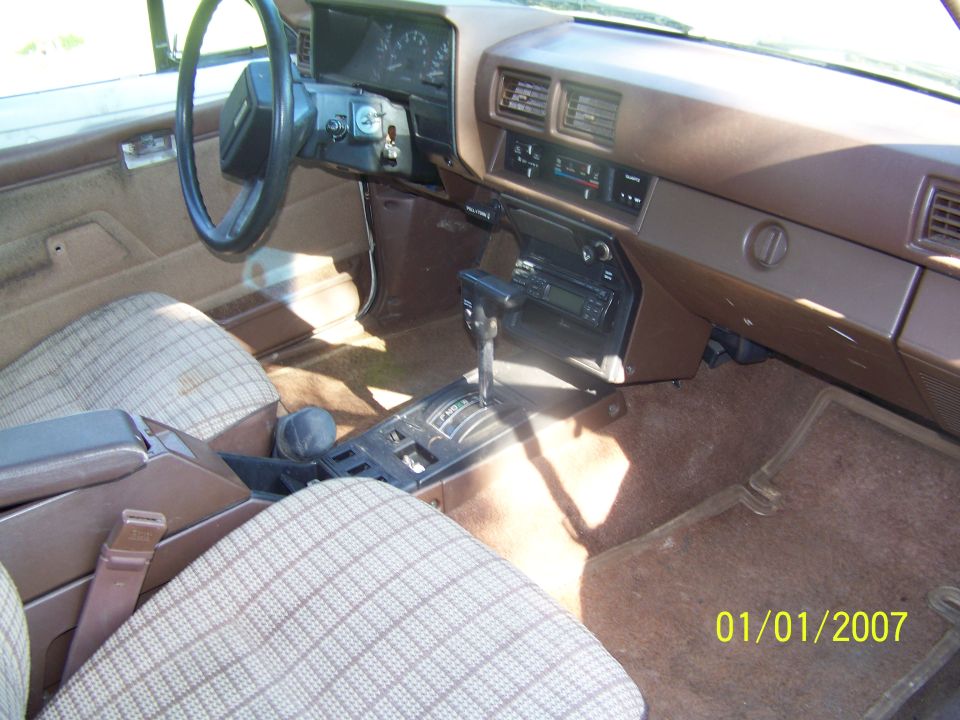 Interior view of a 1988 Suzuki Samurai showing dashboard, steering wheel, automatic transmission shifter, and patterned seats