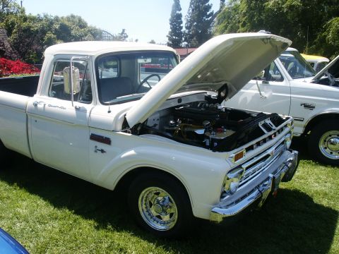 2000 Ford F-250 - A white pickup truck is parked on grass with its hood open, revealing the engine bay.