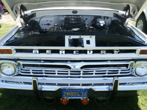2000 Ford F-250 - The engine bay of a Mercury truck is visible, a chrome grille and a California license plate.