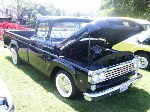 2000 Ford F-250 - This black 1959 Ford F-100 pickup truck has its hood open, revealing the engine bay.