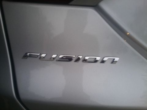 2000 Ford F-250 - Chrome FUSION emblem on a silver car panel.