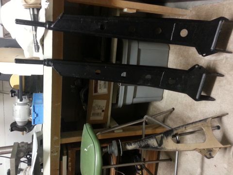 1991 Ford Bronco - Two black lift kit components are shown, with a tan component visible underneath.