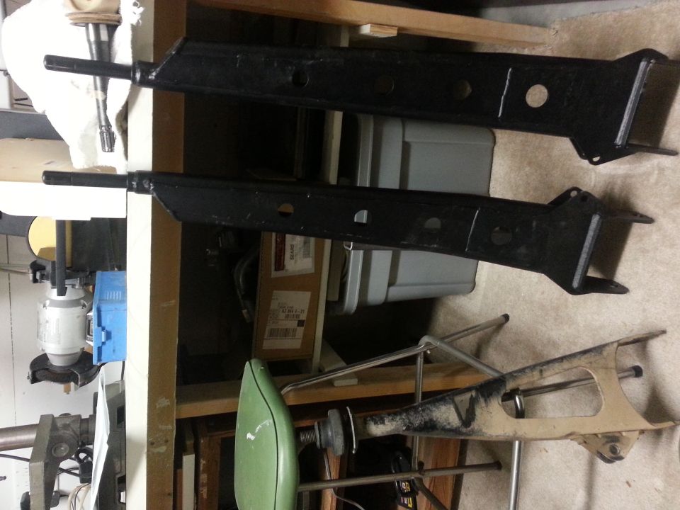 Two black lift kit components, one tan component below