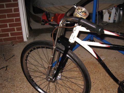 1994 Ford Bronco - Close-up view of a bicycle's front wheel, handlebars, and a small gauge attached to the handlebars.
