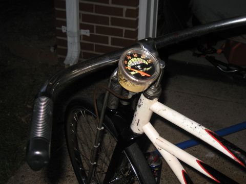 1994 Ford Bronco - Close-up of a vintage Western Flyer bicycle speedometer mounted on the handlebars.