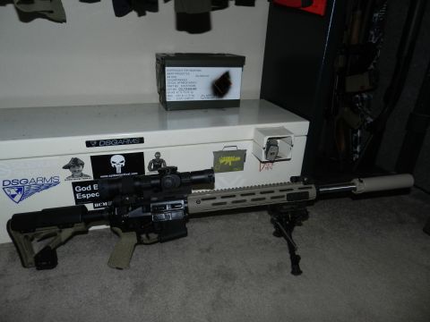 1996 Ford Bronco - AR-15 style rifle with scope and bipod on a storage box.