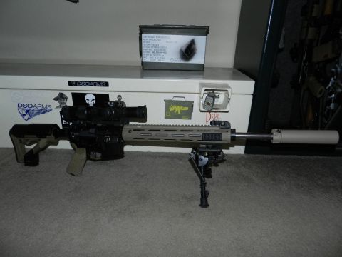1996 Ford Bronco - A tactical rifle is displayed with an ammo box and various stickers on a storage chest.