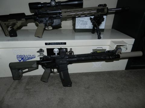 1996 Ford Bronco - Two rifles, one tan and black, the other all black, are displayed with scopes and bipods.