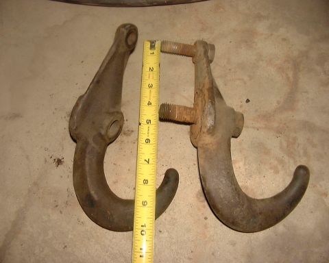 1985 Ford F-150 - Two metal hooks are shown with a measuring tape for scale, indicating their size and condition.