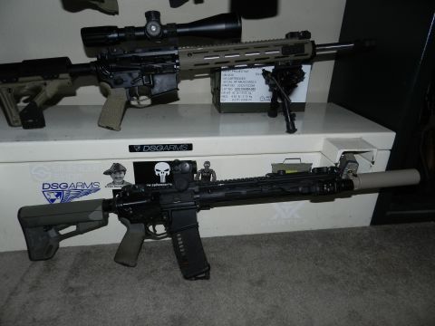 1996 Ford Bronco - Two rifles are displayed on a white storage box with various stickers and markings.