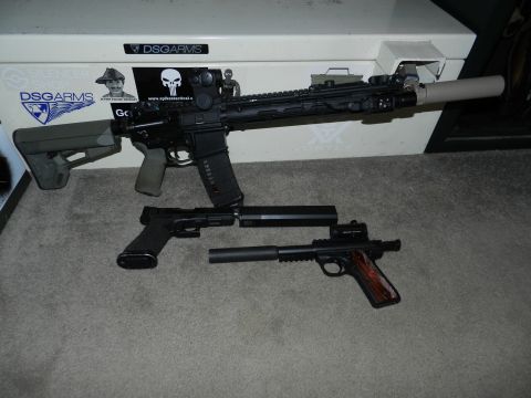 1996 Ford Bronco - Various firearms are displayed on a carpeted surface, with a safe in the background.