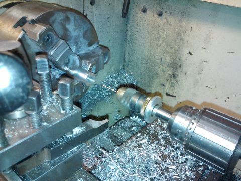 1995 Ford Probe - A close-up view of a metalworking lathe in operation, with a drill bit working on a metal component.