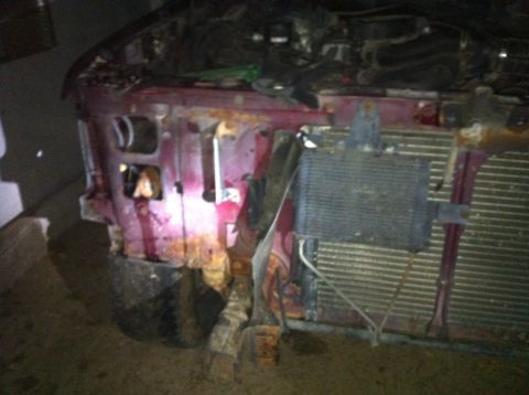 1996 Ford Bronco - Front end of a vehicle showing significant damage to the fender and grille area.