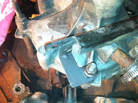 1996 Ford Bronco - This is a close-up view of a bracket attached to a vehicle's engine assembly.