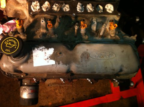1996 Ford Bronco - Close-up of a Ford engine component, showing the valve cover and fuel injectors.
