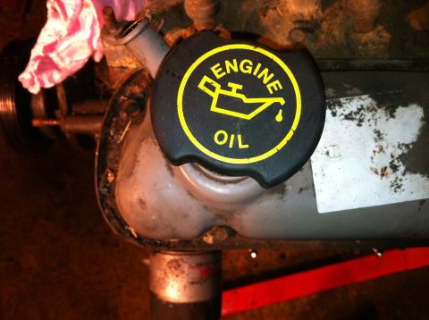 1996 Ford Bronco - Close-up of an engine oil cap with visible text and graphics.