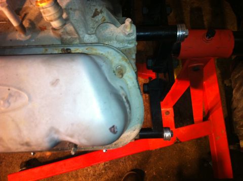 1996 Ford Bronco - Engine oil pan is mounted on a red engine stand for repair or maintenance.