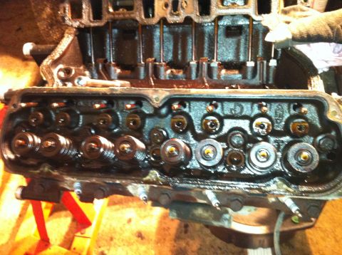 1996 Ford Bronco - Close-up of an engine's cylinder head with internal components exposed.