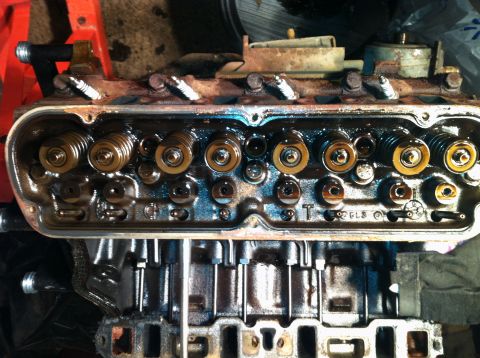 1996 Ford Bronco - Close-up view of an engine's cylinder head, revealing internal components and signs of use.