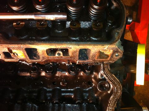 1996 Ford Bronco - Engine cylinder head detail showing internal components and oil buildup.