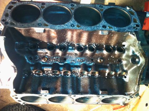 1996 Ford Bronco - Engine block with visible cylinder bores and oil residue.