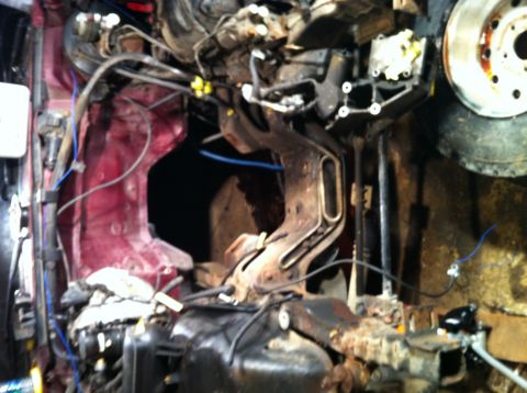 1996 Ford Bronco - Close-up view of a vehicle's engine bay, showing complex mechanical components and wiring.