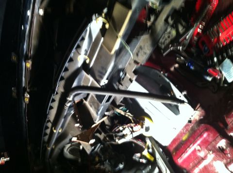 1996 Ford Bronco - The engine bay of a 1996 Ford Bronco shows red paint and a collection of tools.