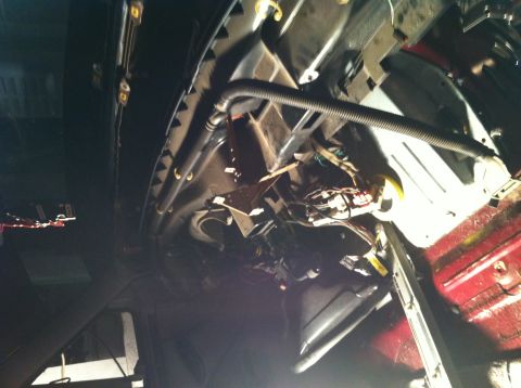 1996 Ford Bronco - Close-up view of the complex wiring and components located under the dashboard of a vehicle.