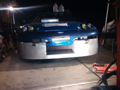 1995 Ford Probe - This modified car has a custom front bumper and a hood scoop, with two bottles on the roof.