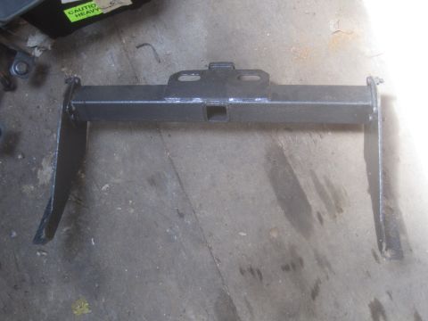 1993 Ford Bronco - Trailer hitch receiver part shown on a concrete floor, with a caution sticker visible in the background.
