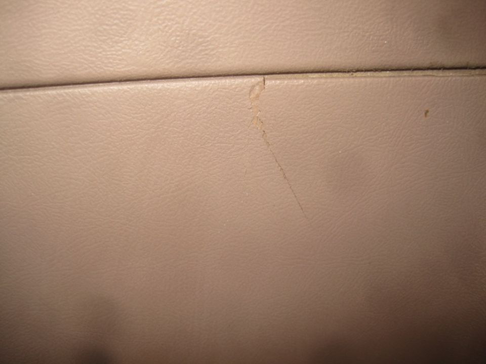 Tan interior panel with a scratch and a small stain