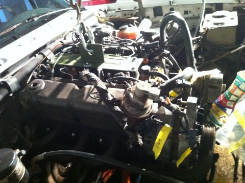 1992 Ford Bronco - Close-up view of a vehicle's engine bay, showing mechanical components and wiring harnesses.