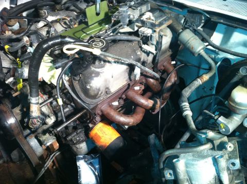 1992 Ford Bronco - Close-up view of an engine bay, showing the oil filter and exhaust manifold.