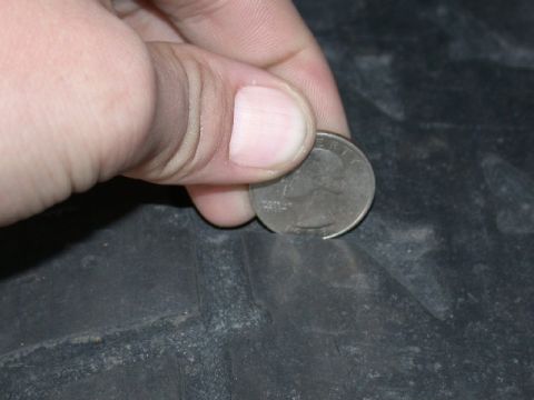 1994 Ford Bronco - Checking tire tread depth with a quarter.
