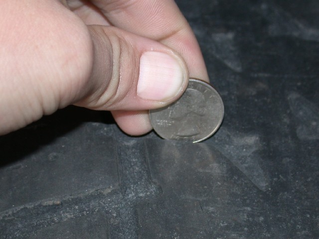 Quarter coin used to measure tire tread depth