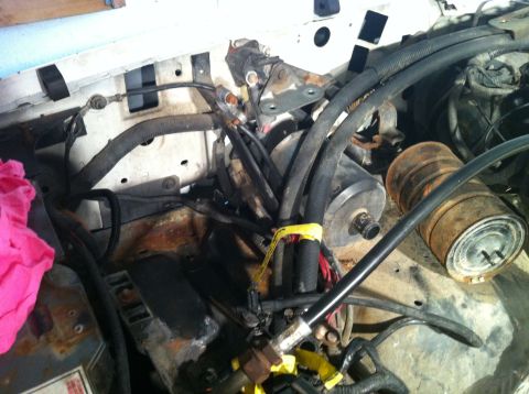 1992 Ford Bronco - A close-up view of a vehicle's engine bay, showing various hoses and wiring.