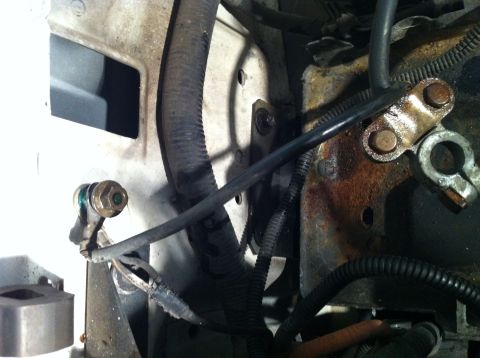 1992 Ford Bronco - Engine bay wiring and battery terminal detail, showing some corrosion and protective loom.