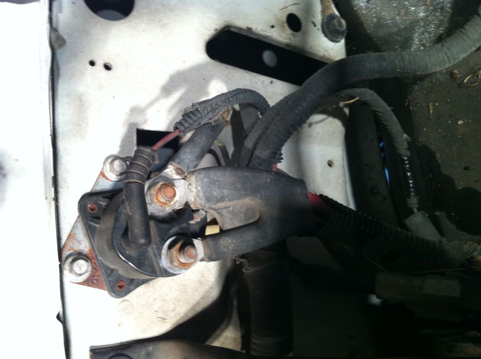 close-up of starter solenoid and thick black wires in engine bay