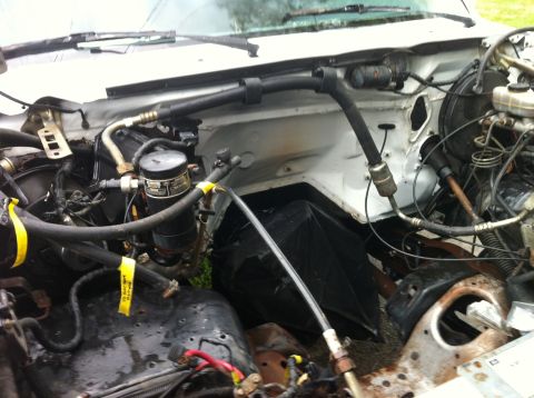1992 Ford Bronco - The engine bay of a vehicle is shown, with various components and wiring visible.