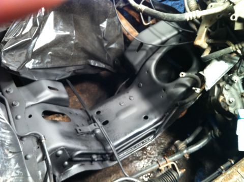 1992 Ford Bronco - Vehicle frame and engine components are visible, some covered with black plastic sheeting.