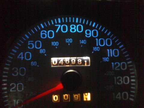2003 Ford Crown Victoria - The vehicle's dashboard shows the speedometer and odometer readings at night.