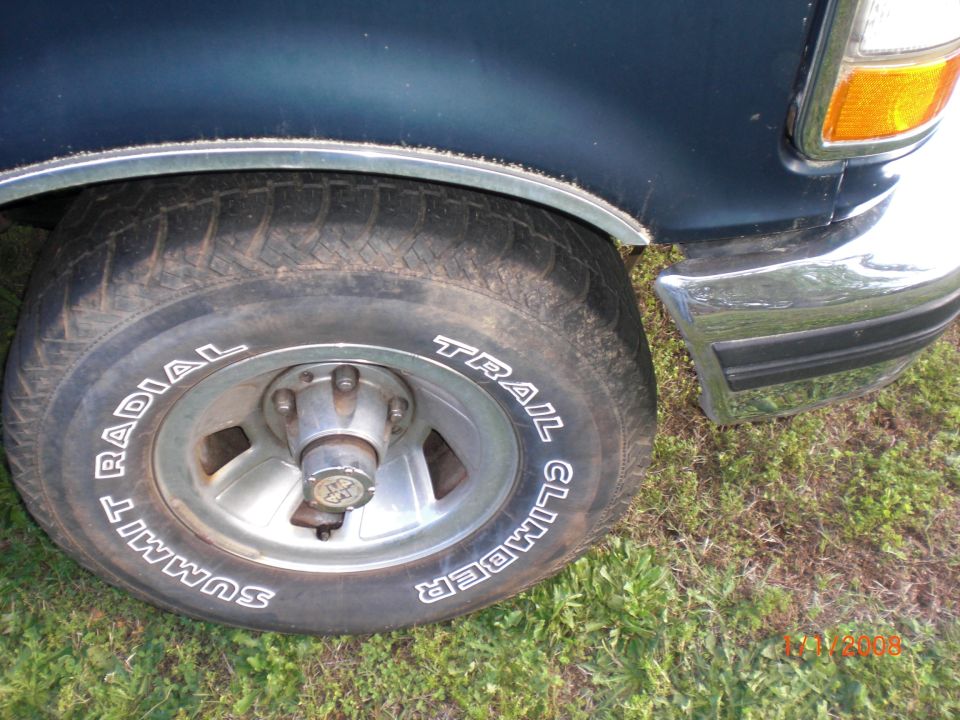 1993 Ford Bronco front wheel with Summit Trail Climber tires and chrome bumper
