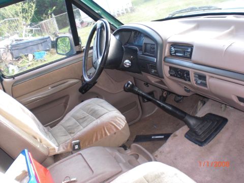 1993 Ford Bronco - The interior of a truck shows a floor shifter and dashboard details.