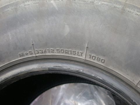 1994 Ford Bronco - The tire sidewall displays its size and a DOT code, indicating it's a part, not a specific vehicle model year.